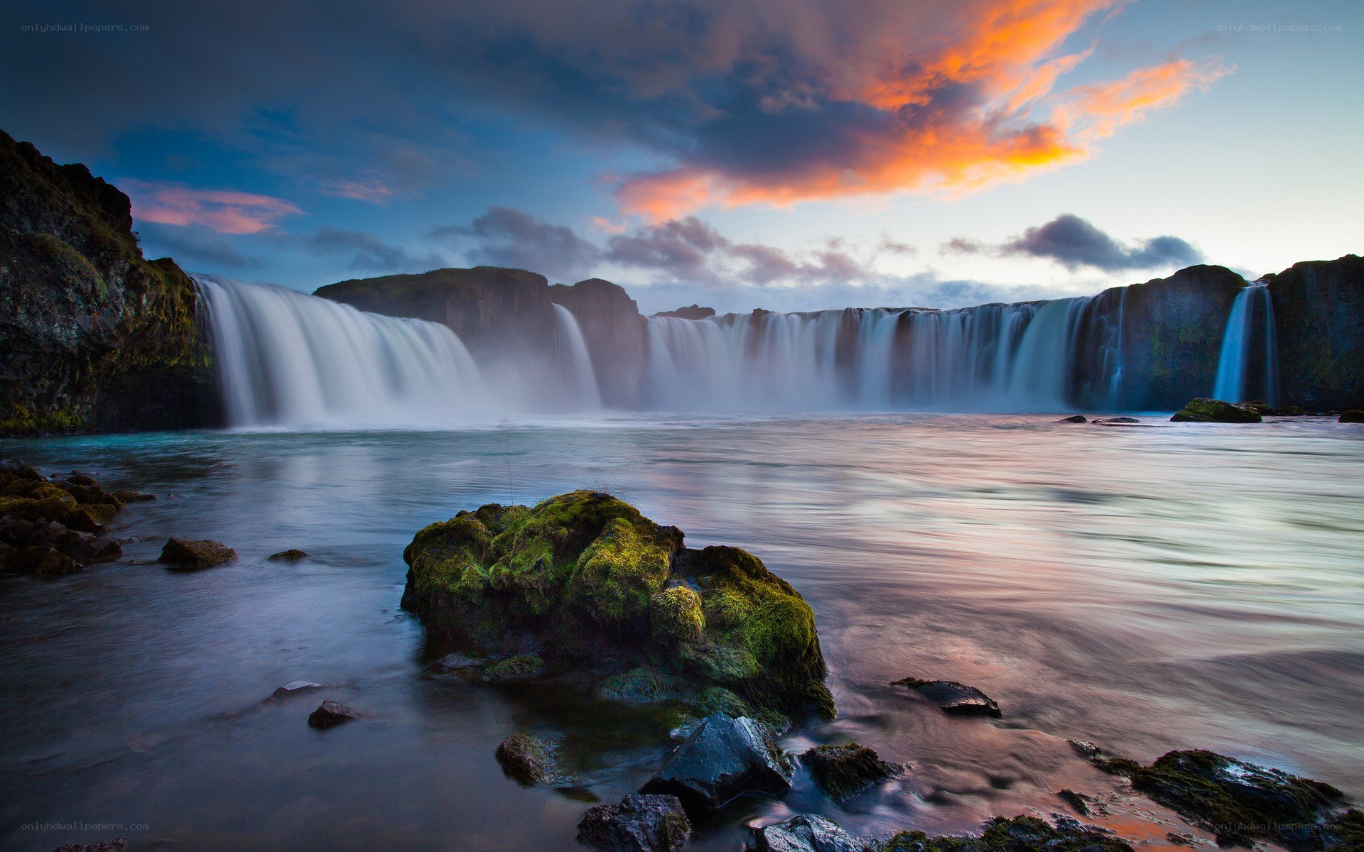 Waterfall at sunset with colorful sky