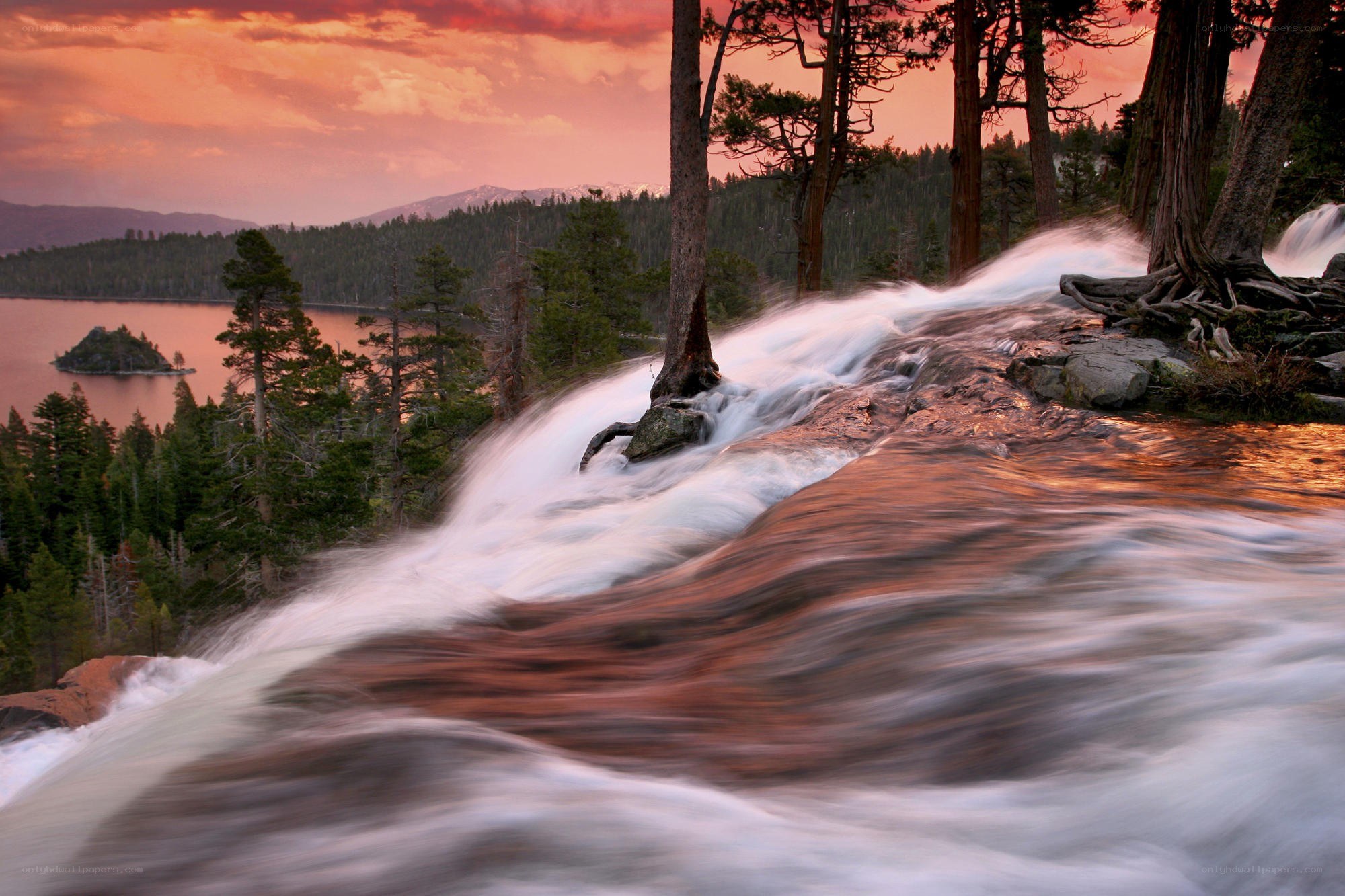 Waterfall at sunset with lake view