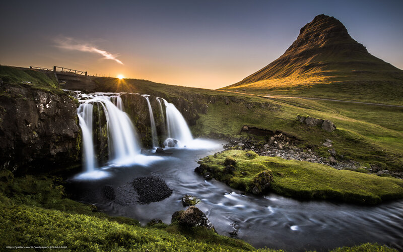 Waterfall at sunset with mountain
