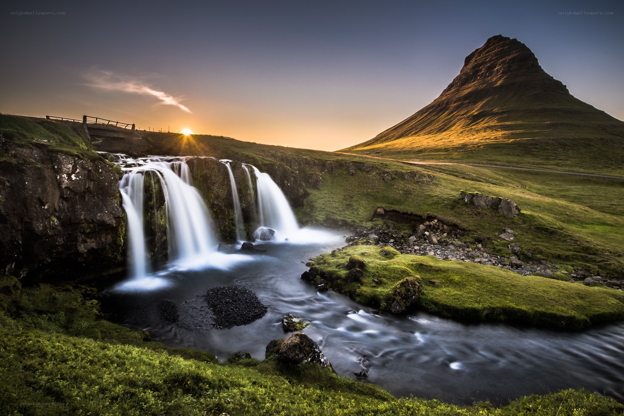 Waterfall at sunset with mountain