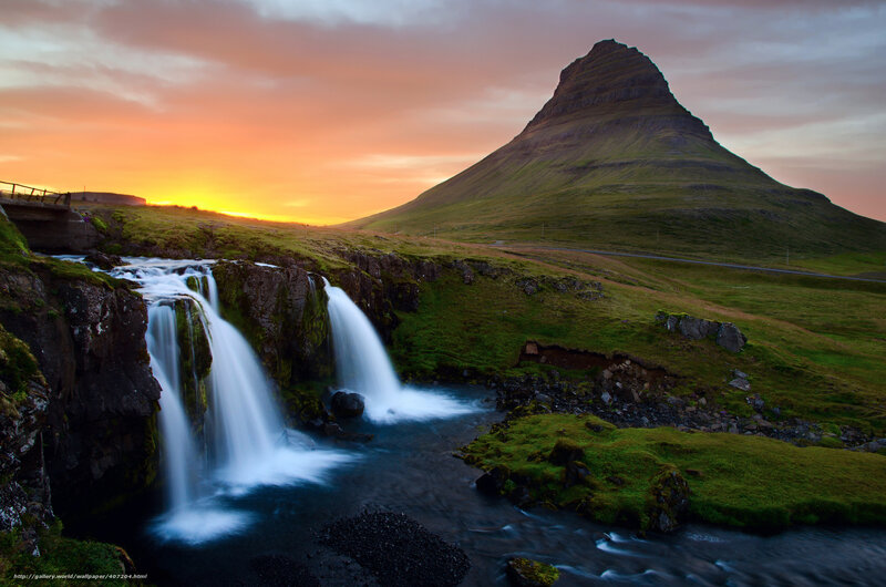 Waterfall at sunset with mountain