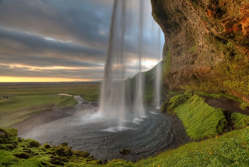 Waterfall behind a cliff