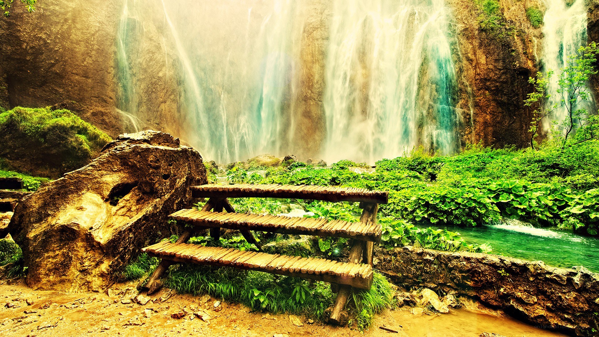 Waterfall bench in lush greenery