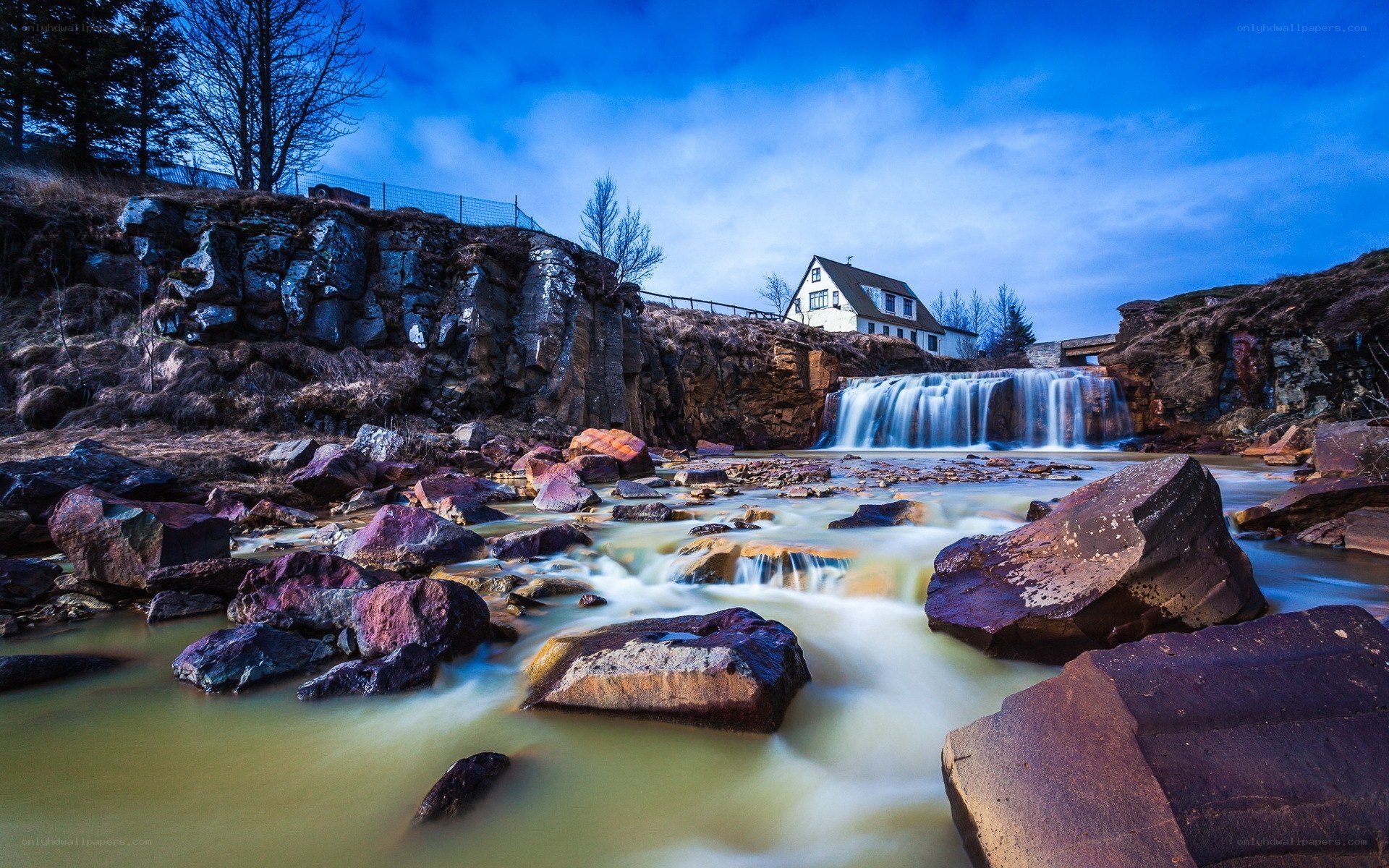 Waterfall by a house in Iceland