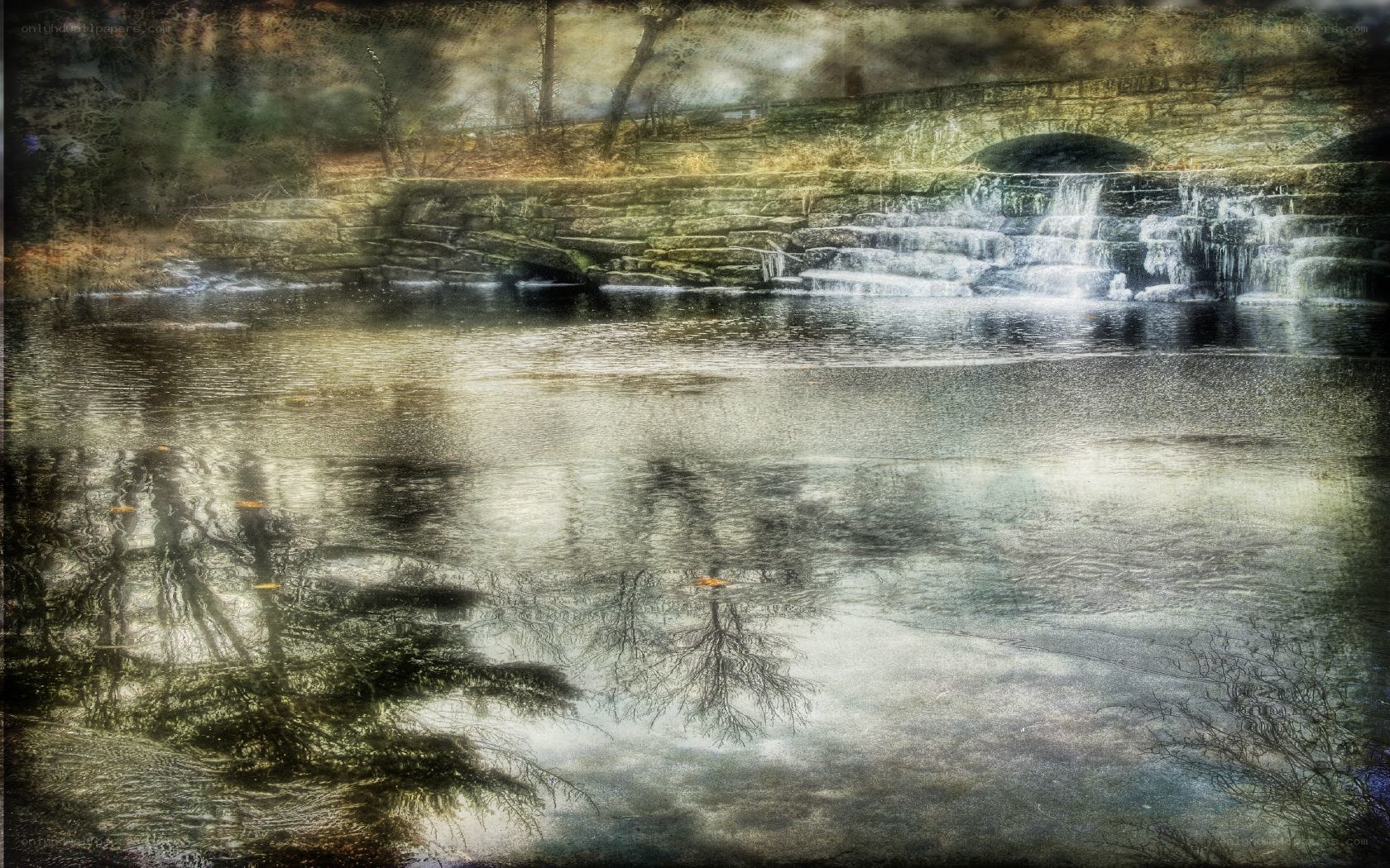 Waterfall by stone bridge