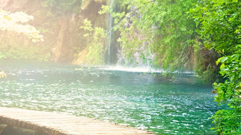 Waterfall by wooden dock