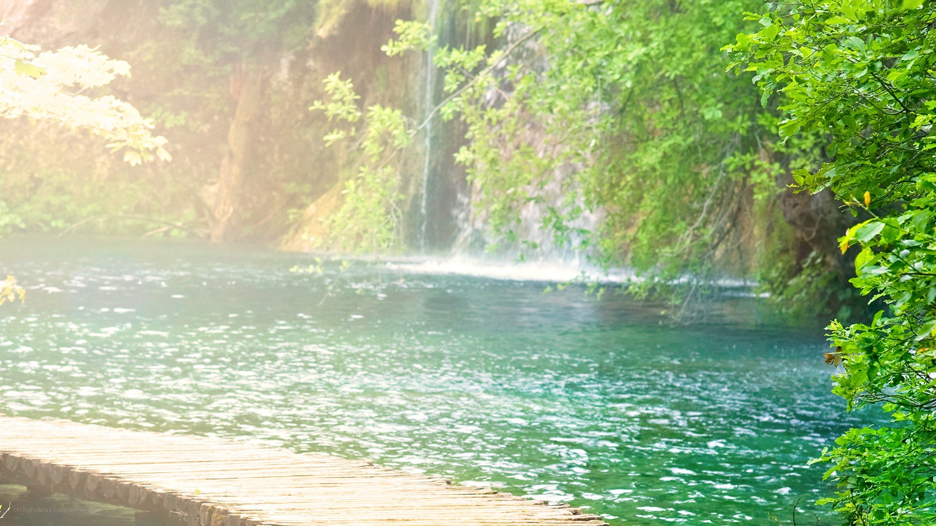 Waterfall by wooden dock