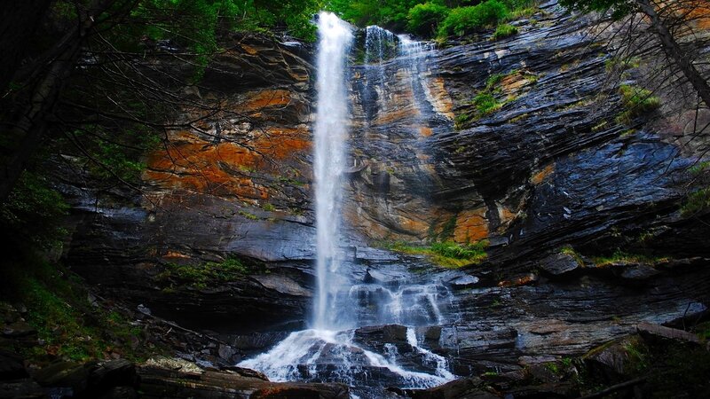 Waterfall cascading down rocky cliff