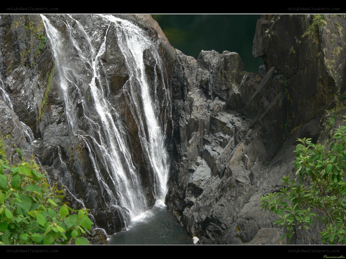 Waterfall cascading down rocky cliff