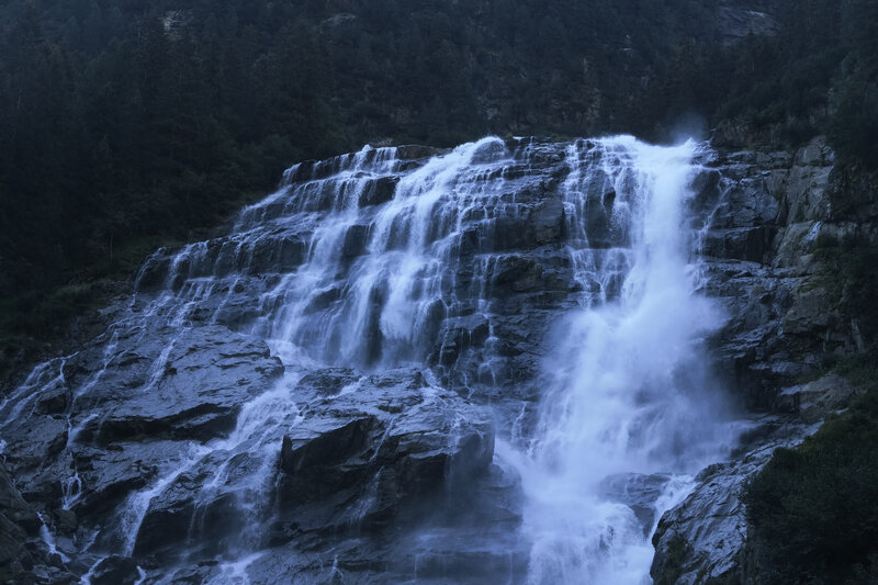 Waterfall cascading down rocky cliff