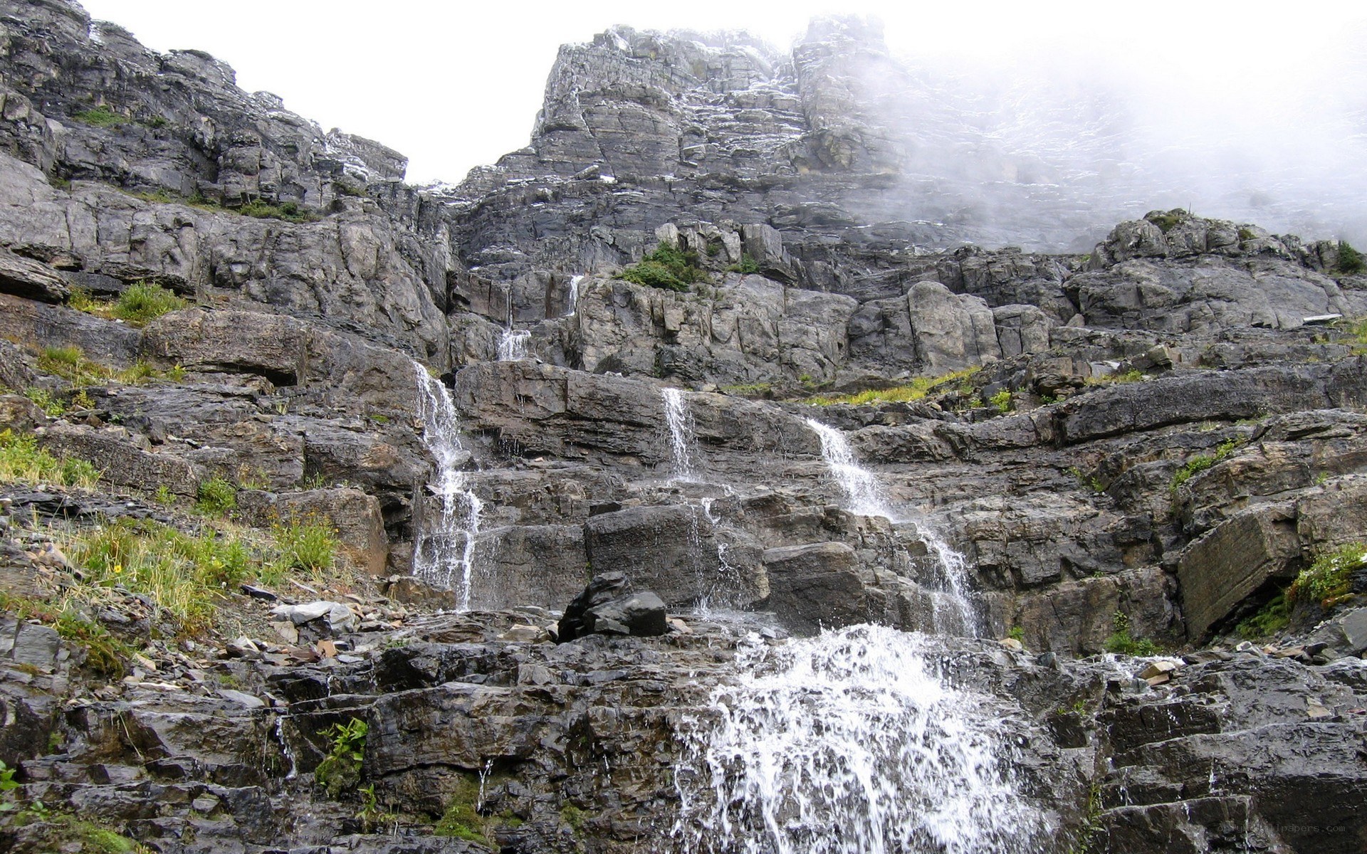 Waterfall cascading down rocky cliff