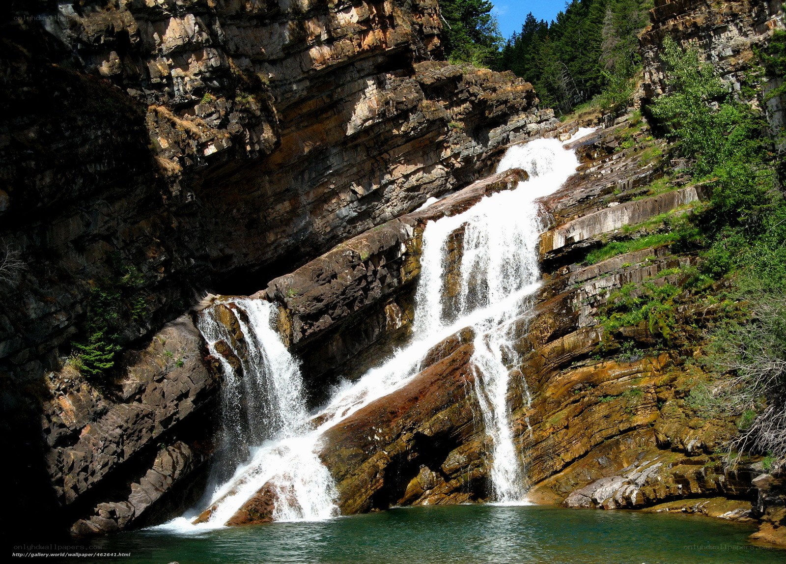 Waterfall cascading down rocky cliff