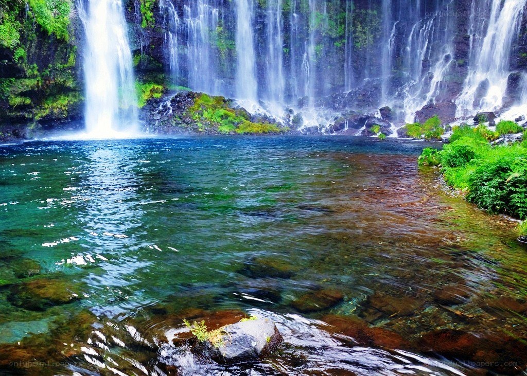 Waterfall cascading into a clear pool