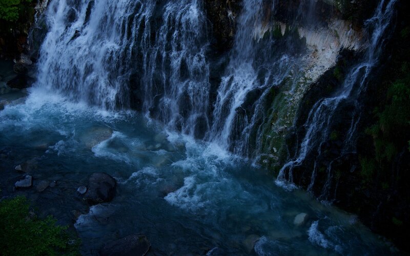 Waterfall cascading into a river