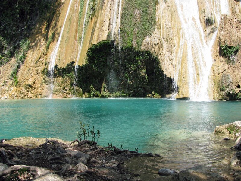 Waterfall cascading into turquoise pool