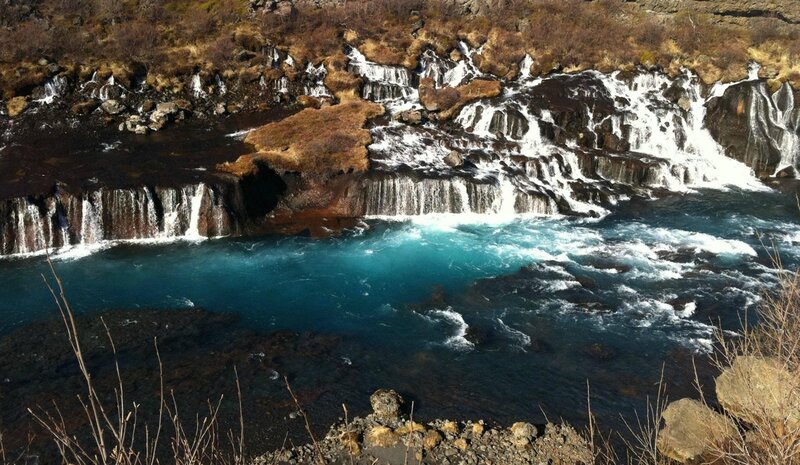 Waterfall cascading into turquoise pool
