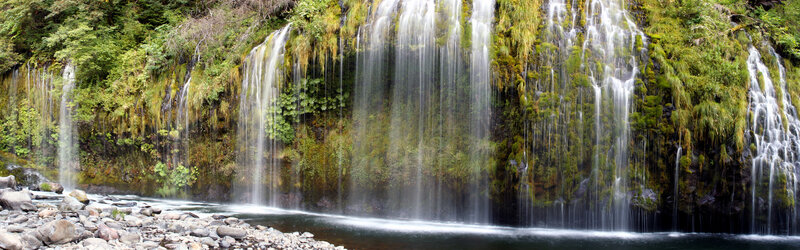 Waterfall cascading over mossy cliff