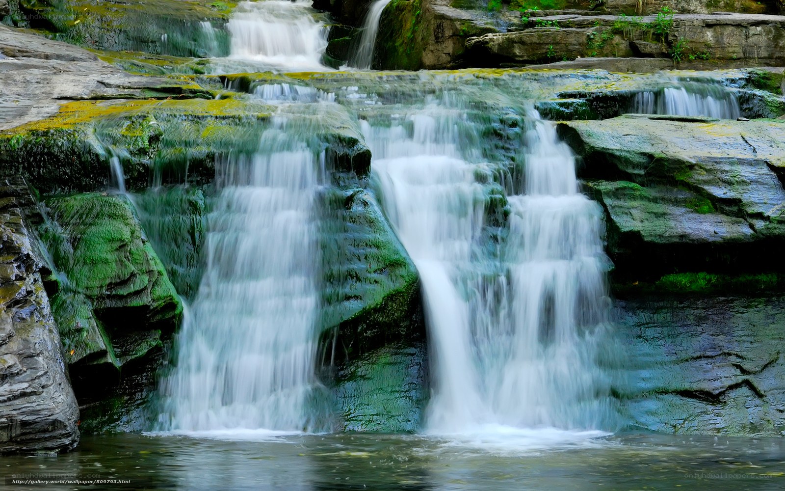 Waterfall cascading over mossy rocks