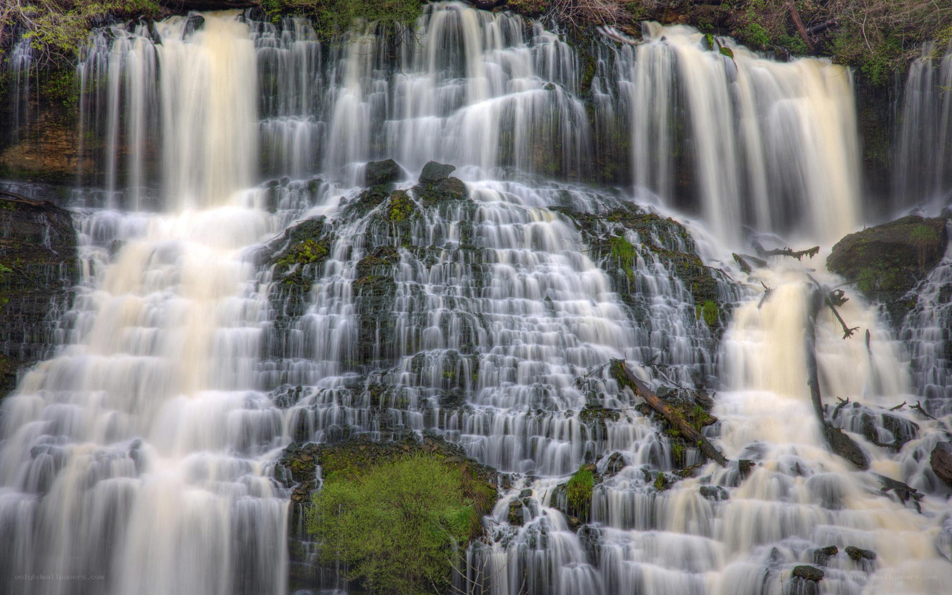 Waterfall cascading over mossy rocks