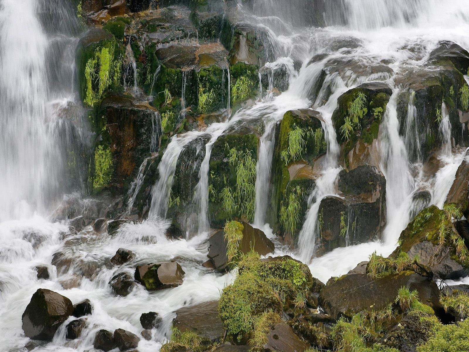 Waterfall cascading over mossy rocks