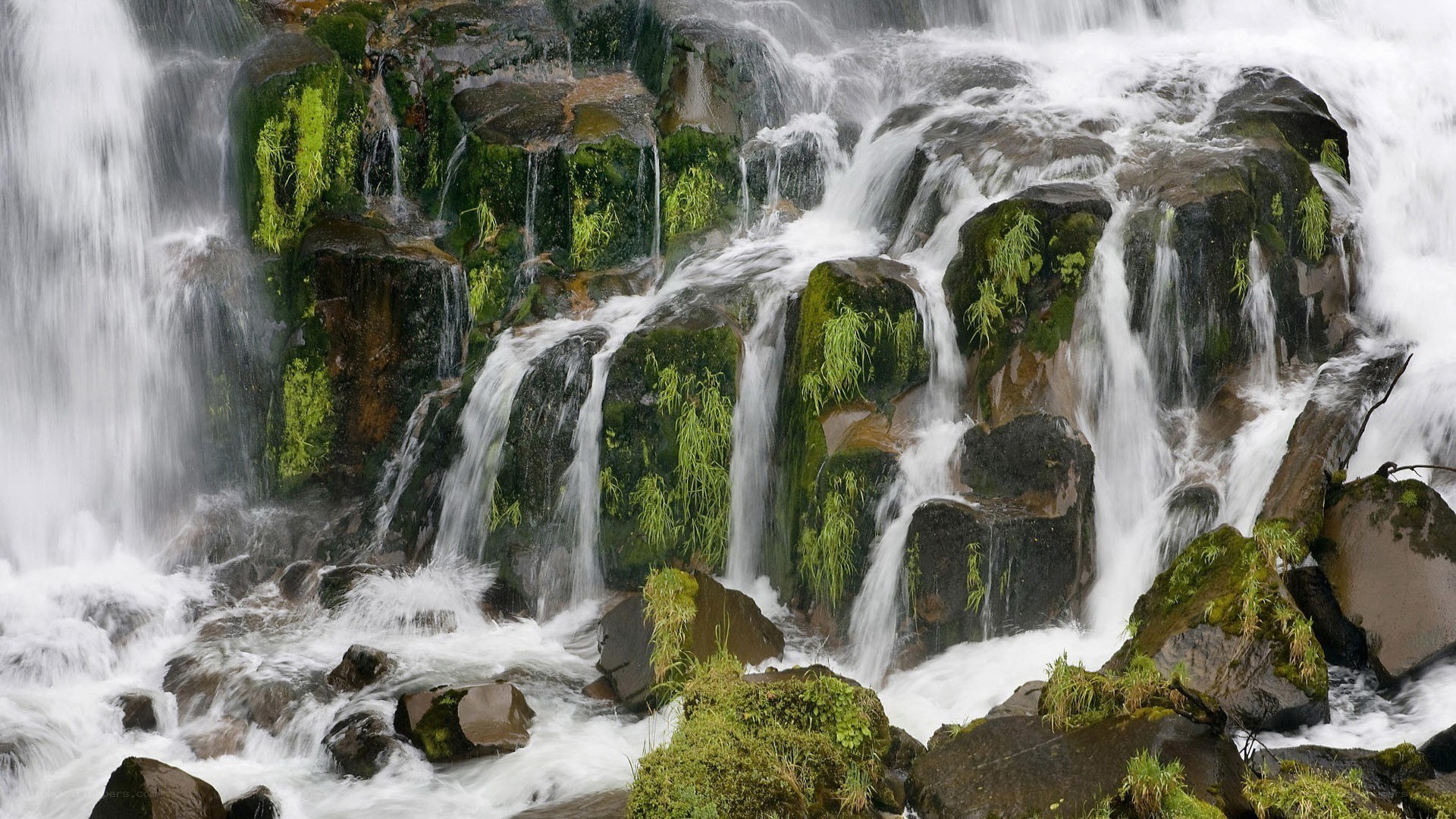 Waterfall cascading over mossy rocks