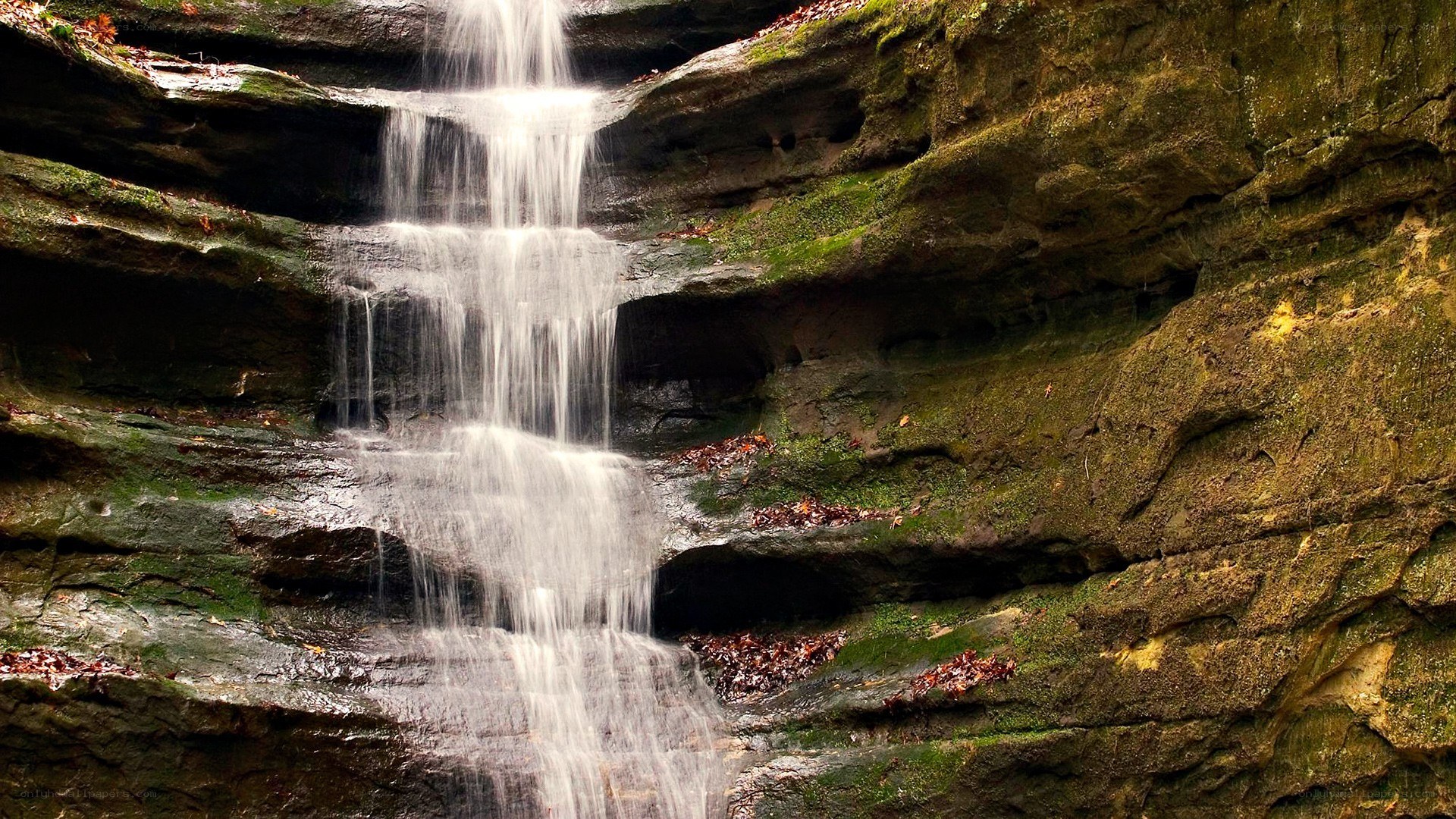 Waterfall cascading over mossy rocks
