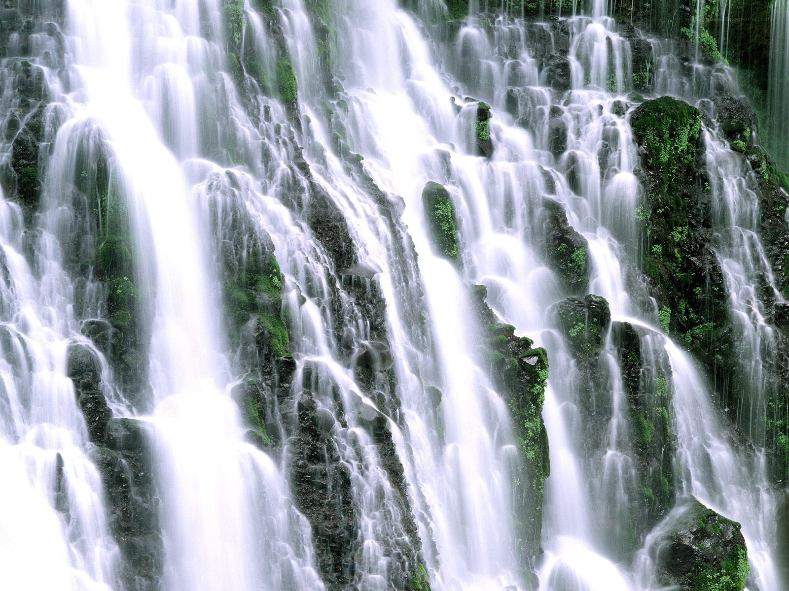 Waterfall cascading over mossy rocks