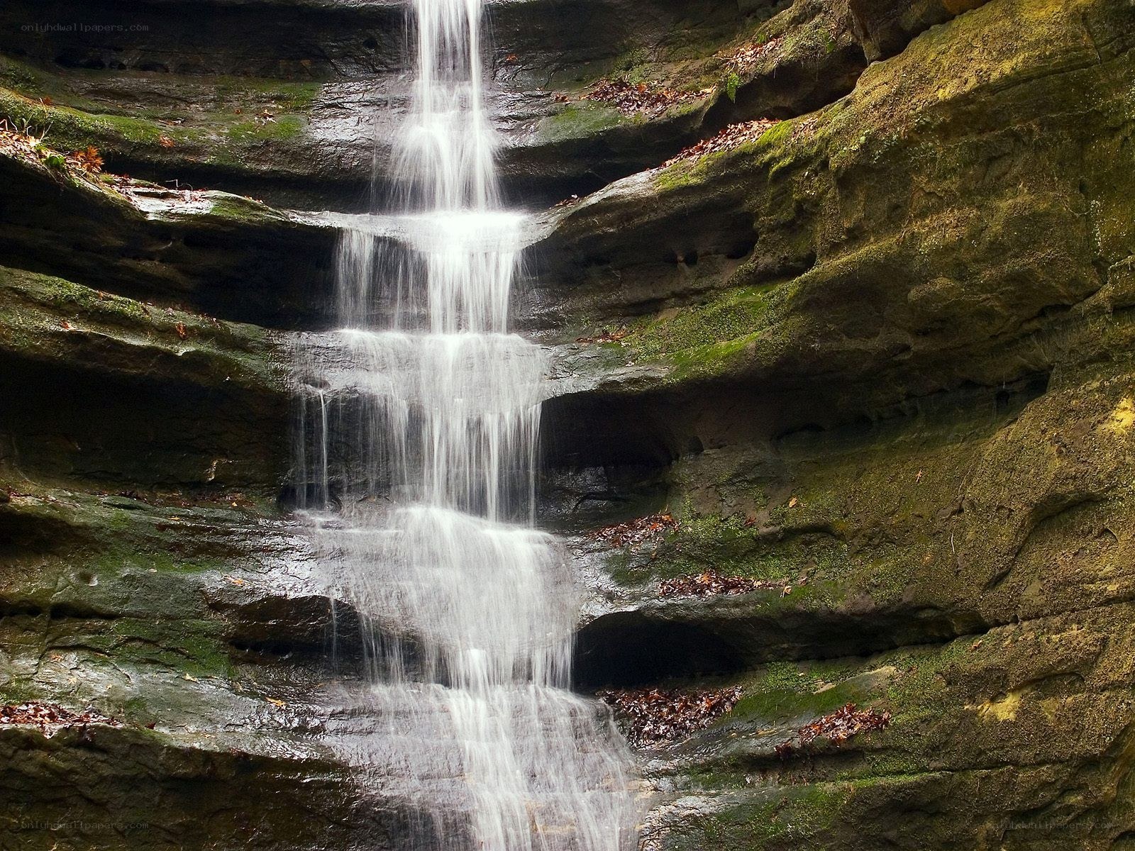 Waterfall cascading over mossy rocks