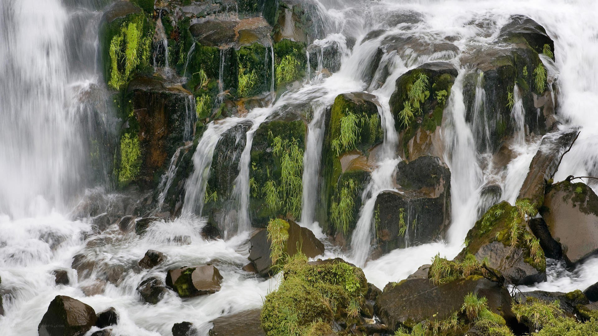 Waterfall cascading over mossy rocks