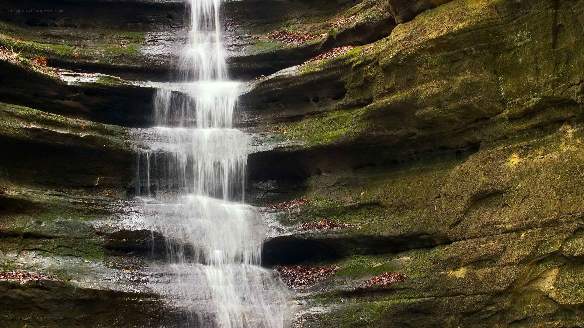 Waterfall cascading over mossy rocks