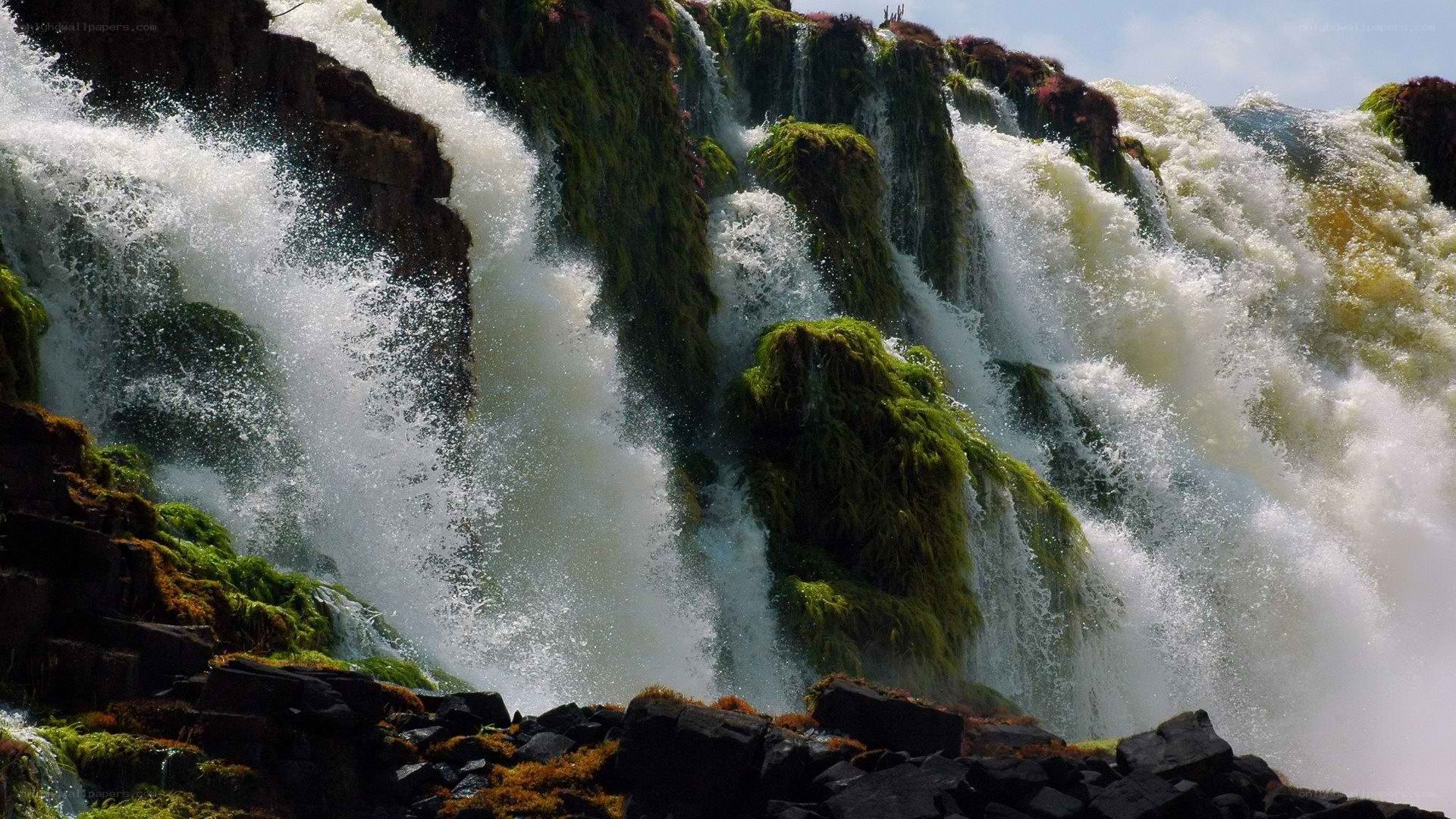 Waterfall cascading over mossy rocks