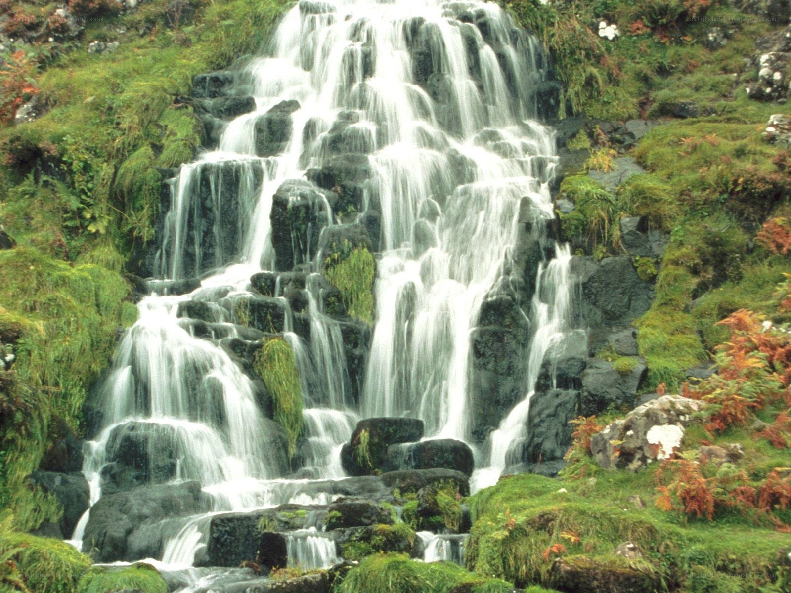Waterfall cascading over mossy rocks