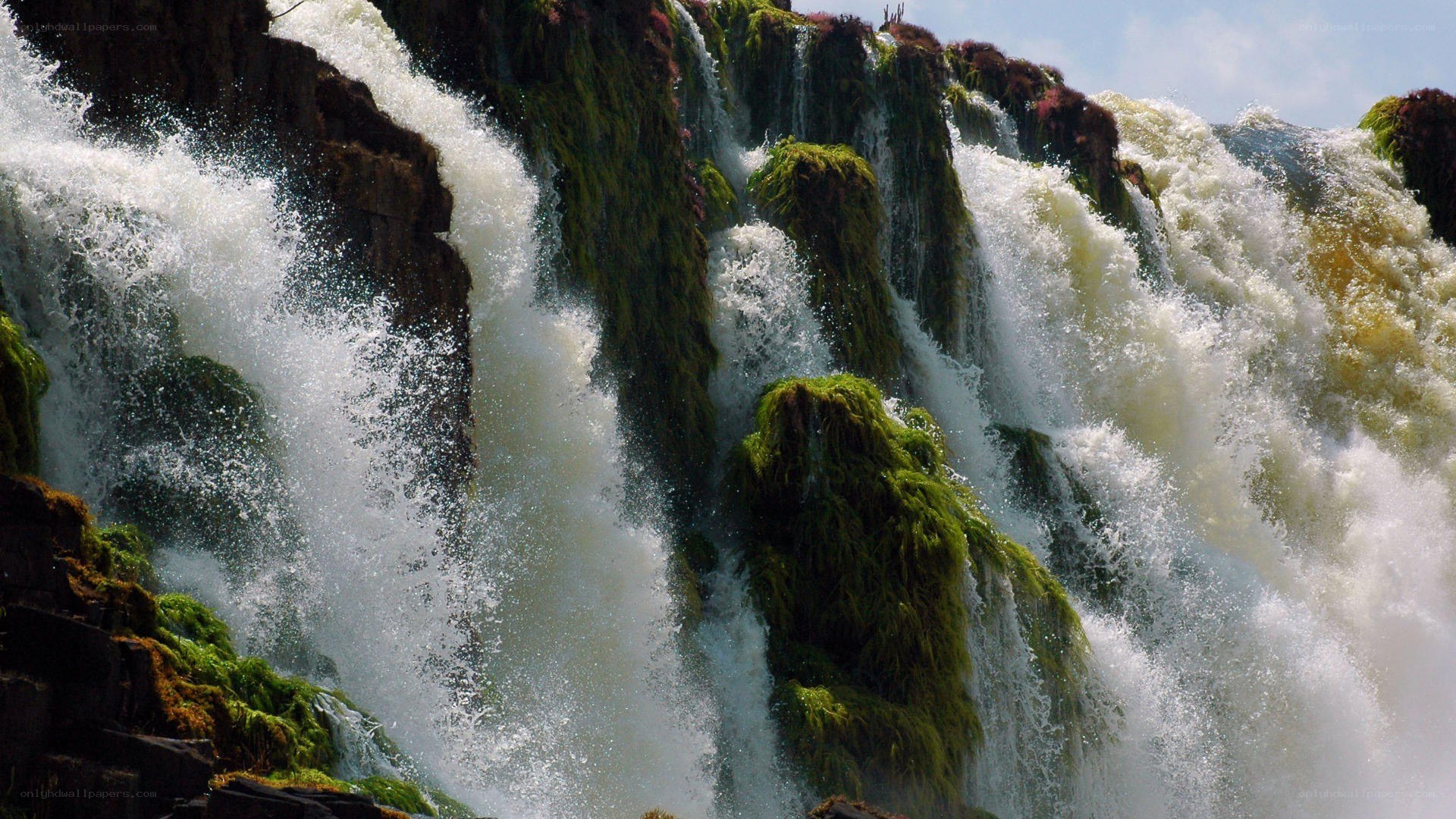 Waterfall cascading over mossy rocks