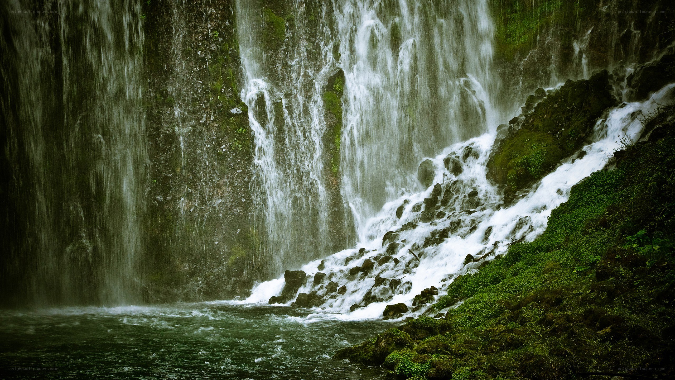 Waterfall cascading over mossy rocks