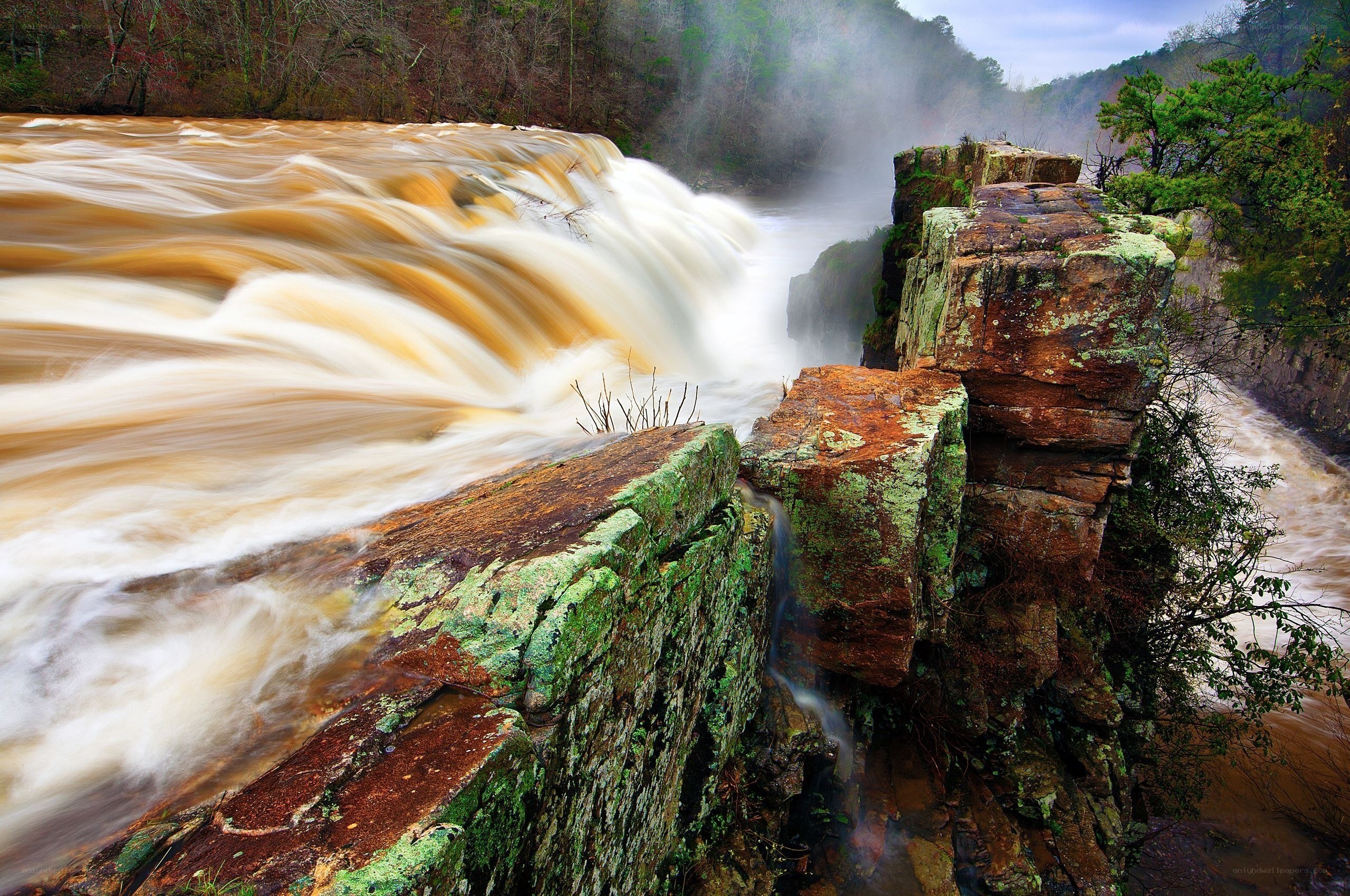 Waterfall cascading over mossy rocks