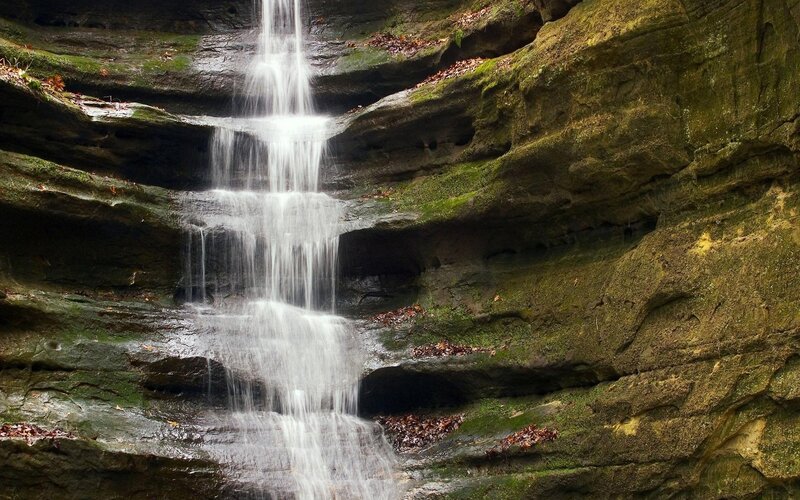 Waterfall cascading over mossy rocks