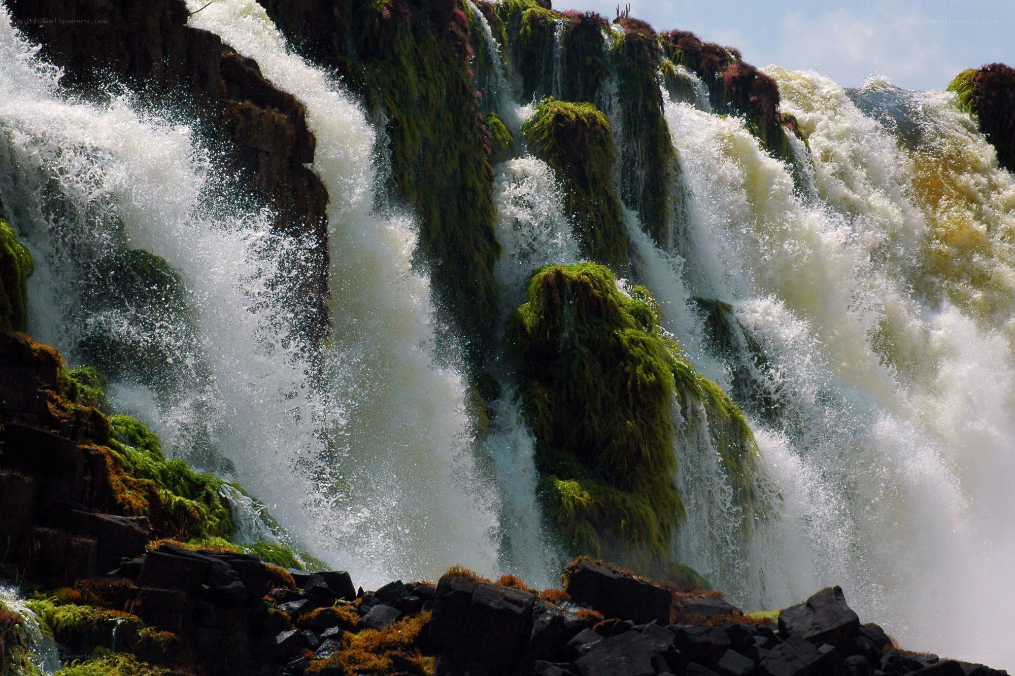 Waterfall cascading over mossy rocks