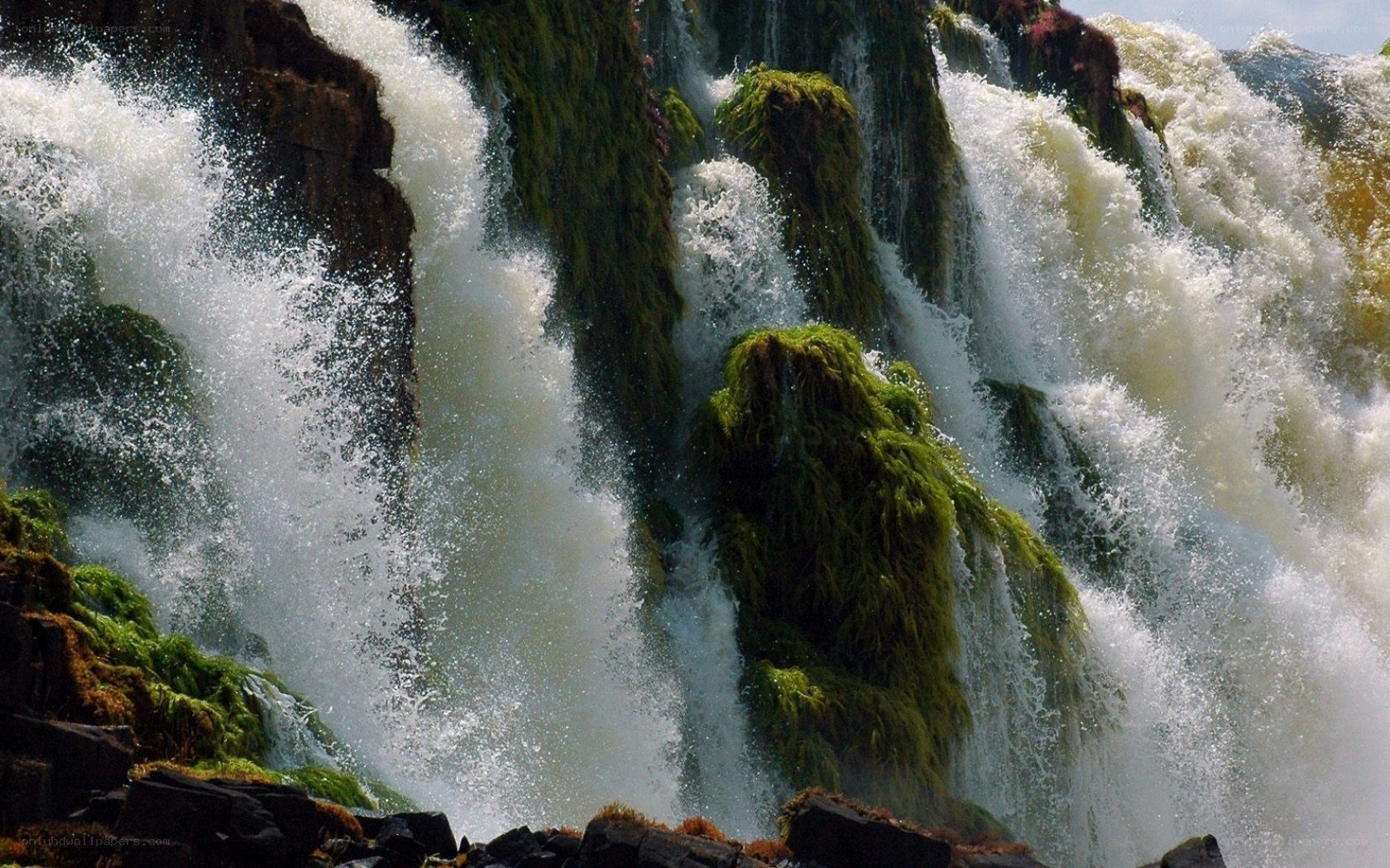 Waterfall cascading over mossy rocks