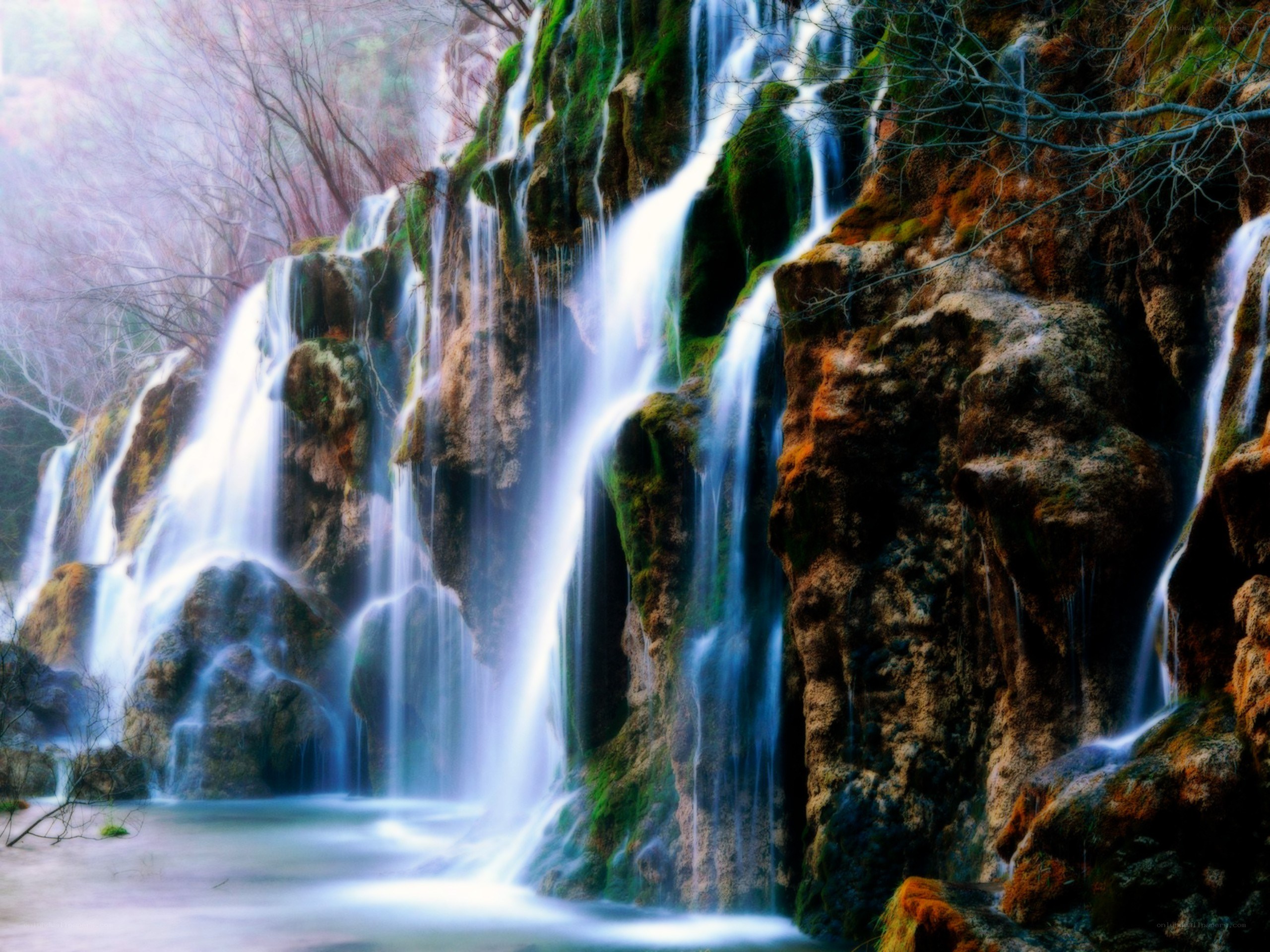 Waterfall cascading over mossy rocks