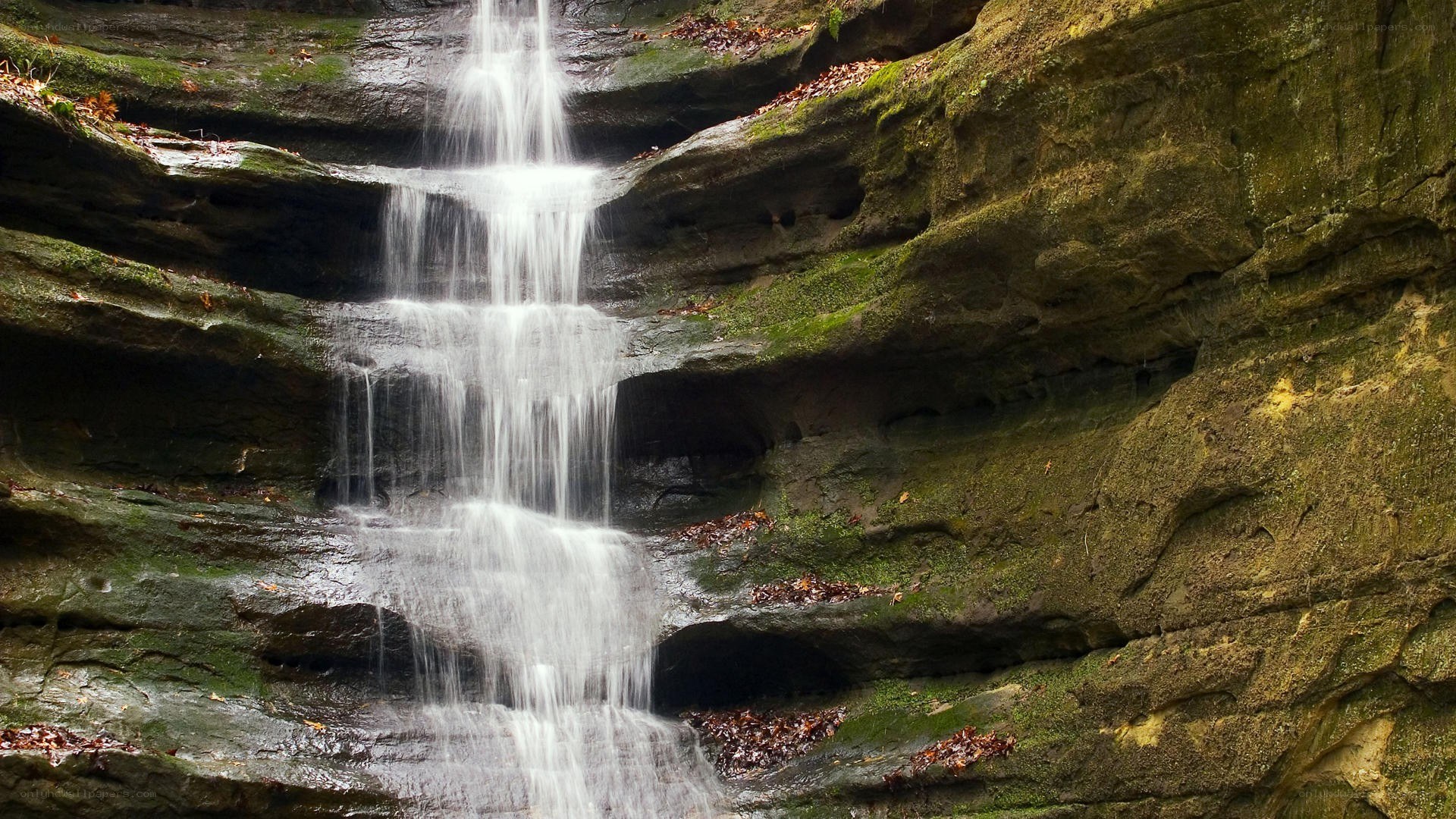 Waterfall cascading over mossy rocks