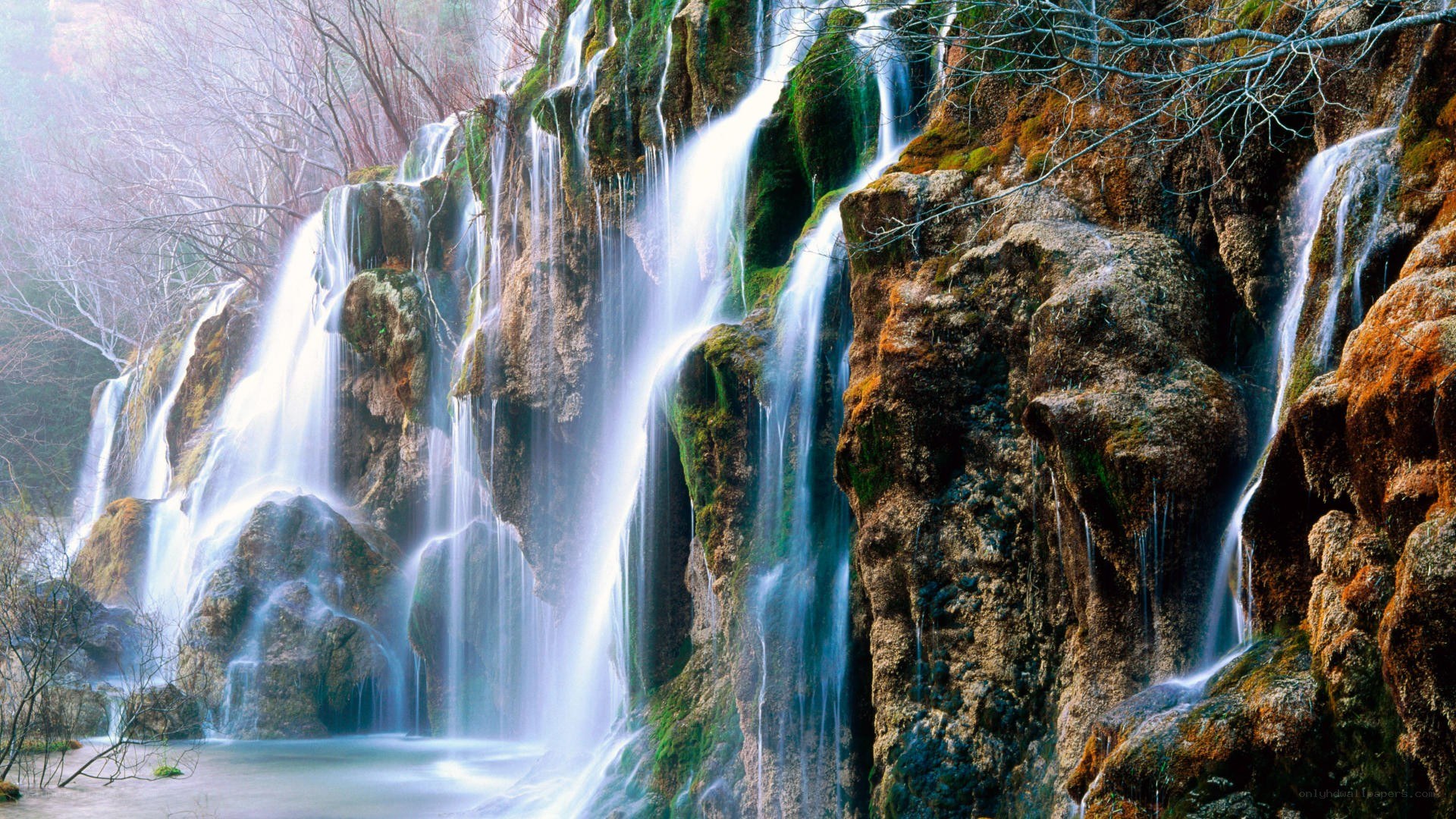 Waterfall cascading over mossy rocks