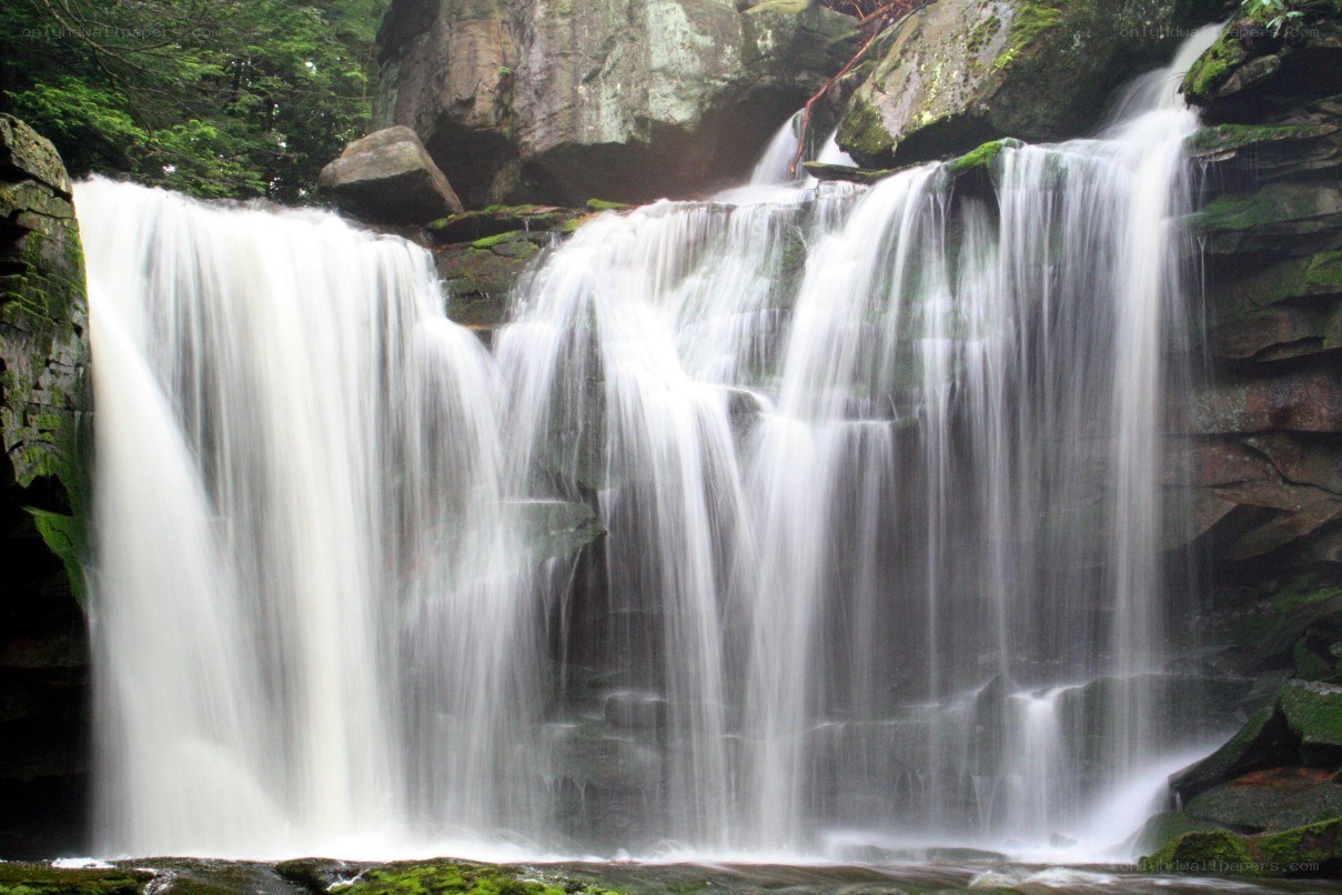 Waterfall cascading over mossy rocks