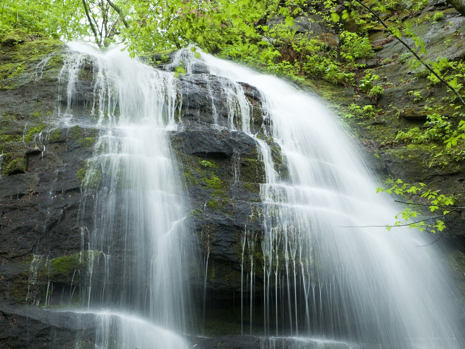 Waterfall cascading over mossy rocks