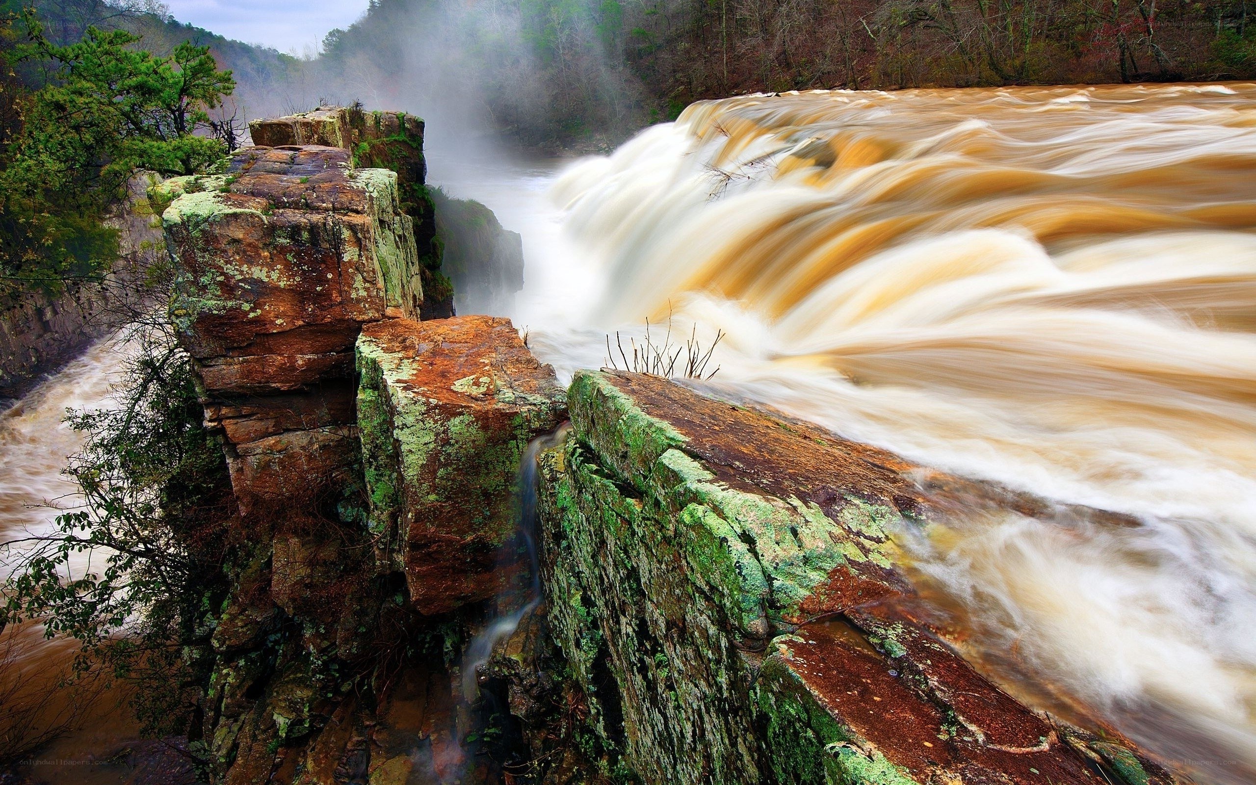 Waterfall cascading over mossy rocks