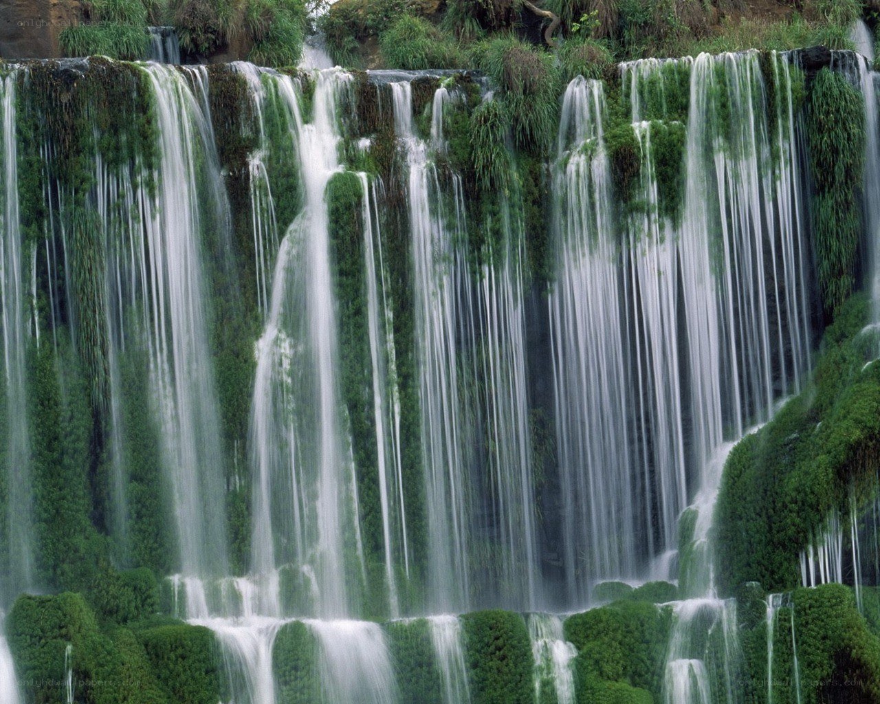 Waterfall cascading over mossy rocks