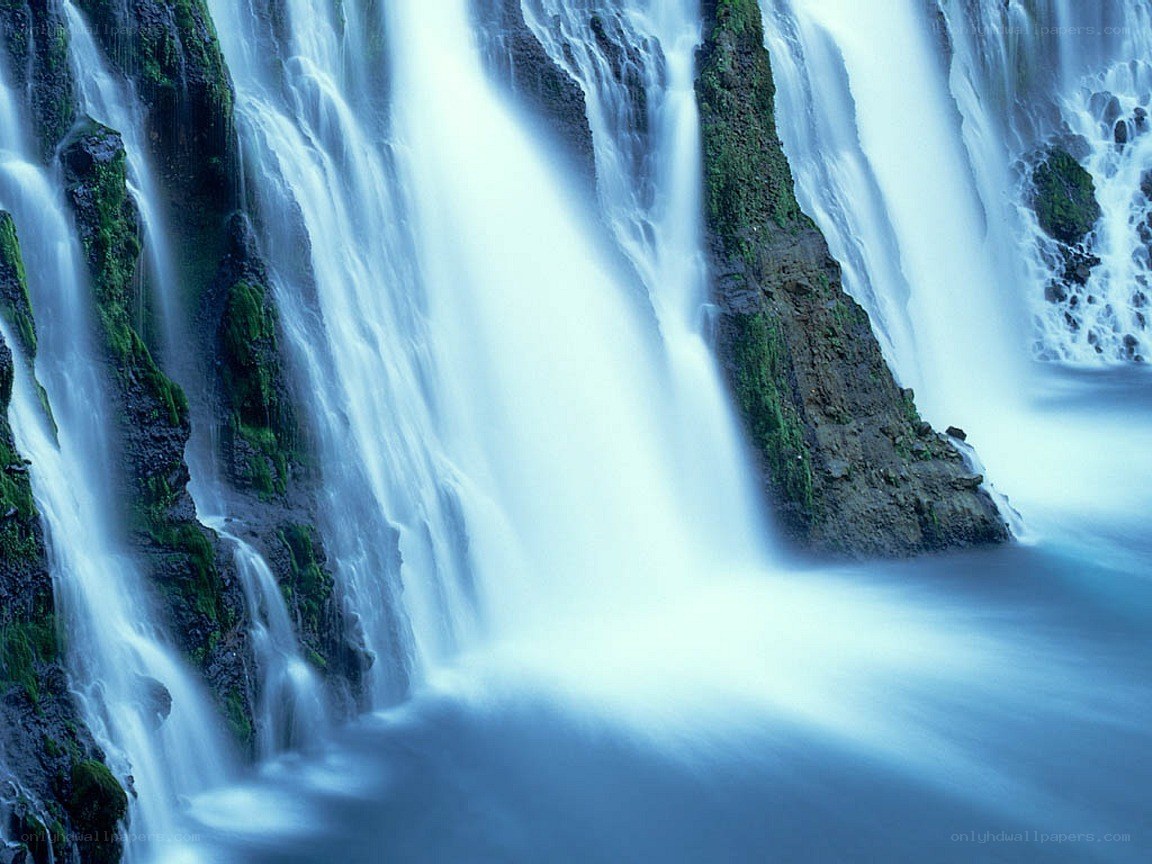 Waterfall cascading over mossy rocks