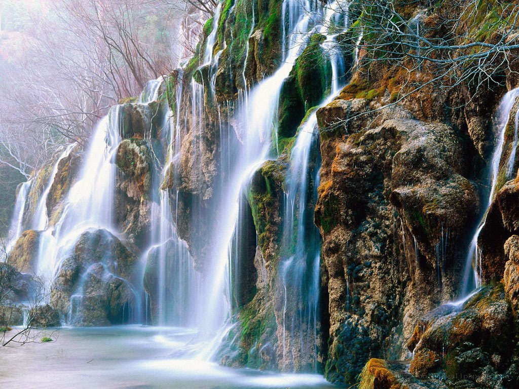 Waterfall cascading over mossy rocks