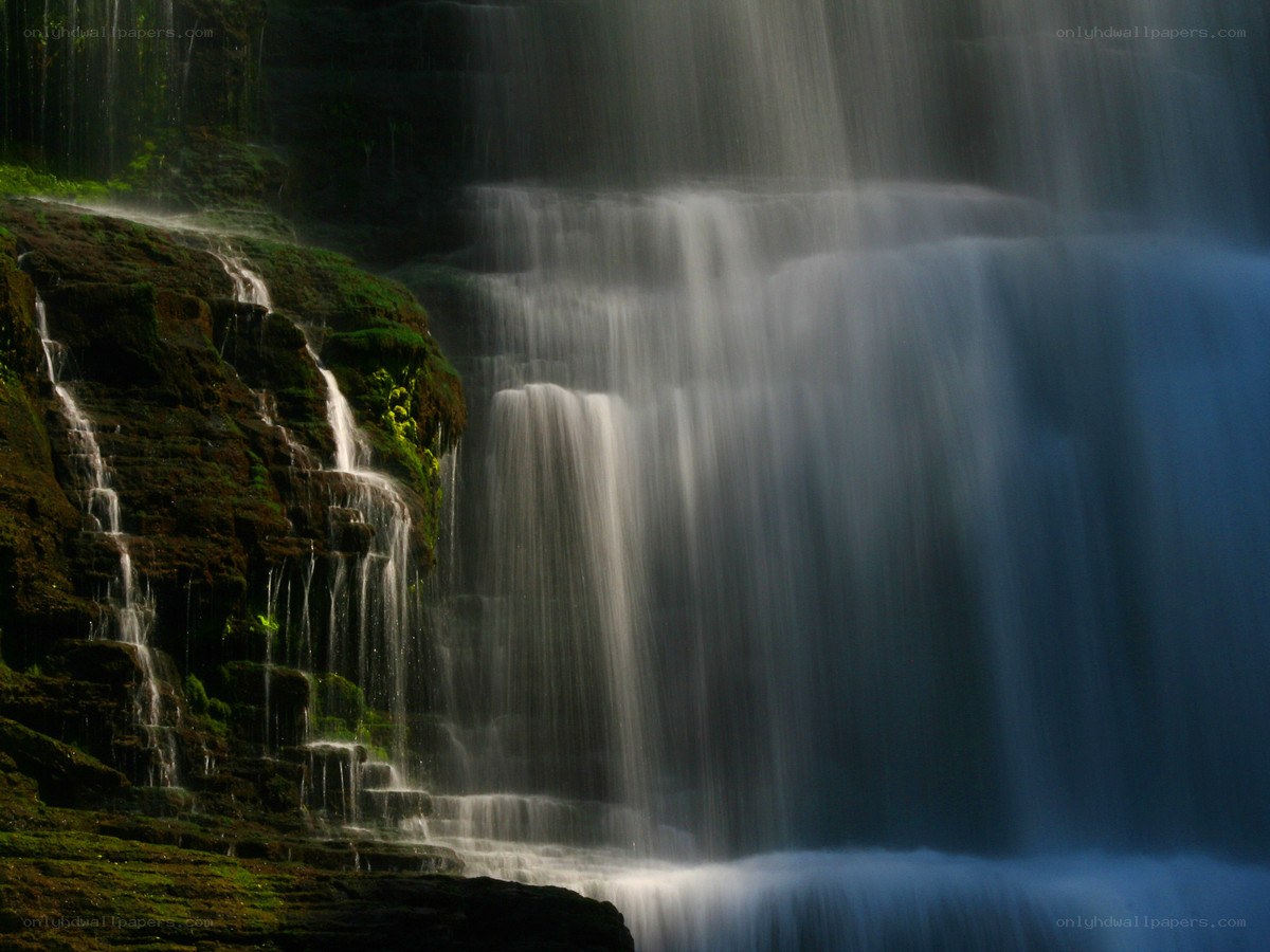 Waterfall cascading over mossy rocks