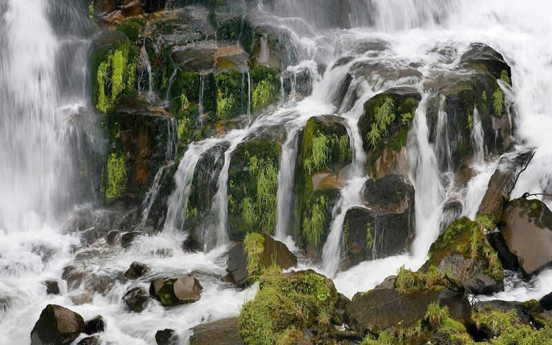 Waterfall cascading over mossy rocks