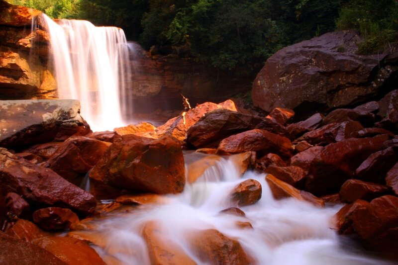 Waterfall cascading over red rocks